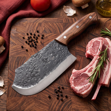 Rhino hand forged cleaver knife shown with ribeye steak, dark forge scale blade